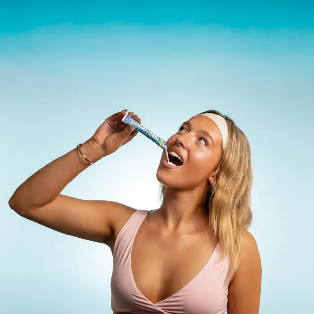 Athlete pouring a Creatine Fizz Stik straight into her mouth